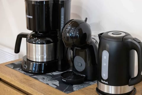 Fully equipped kitchenette with electric kettle and coffee maker.