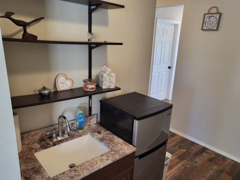 Upstairs wet bar with Refrigerator and sink, also includes an ice bucket.