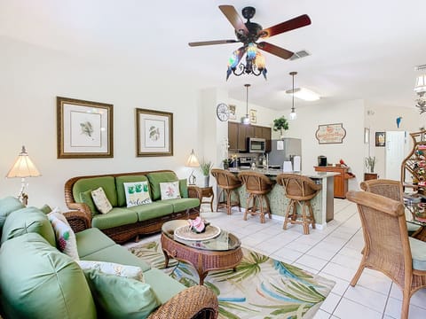 Spacious living room with tropical decor, perfect for relaxing with family or friends.