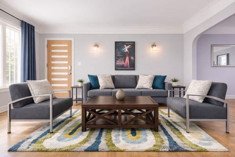 Bright, stylish living room with cozy seating, smart TV, and natural light — perfect for relaxing after exploring Los Angeles