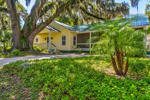 The house features an open screened-in porch between the main house and studio.