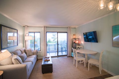 Living area with view of balcony and ocean front