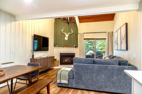 Open living room with vaulted ceilings and private deck.
