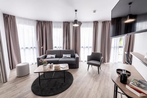 Apartment, 1 Bedroom | Living area | 26-inch flat-screen TV with digital channels, offices