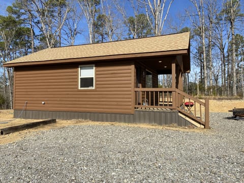 side view of cabin. Water hose and plug in access for guest use