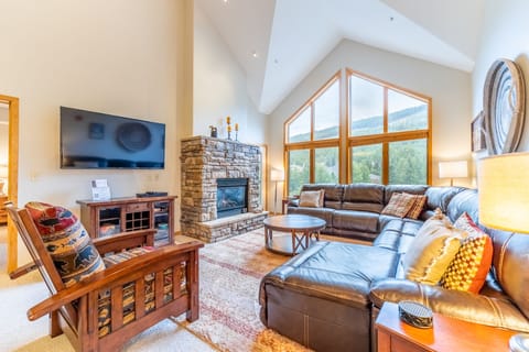 Sink into plush leather sofas while your fireplace crackles and mountain views frame your perfect alpine retreat.