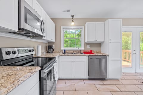 Full Kitchen stocked with plenty of cookware, silverware  and dinnerware