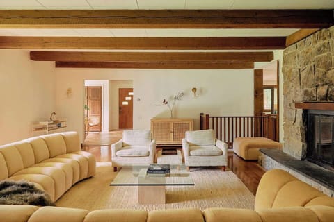 Living Room // Spacious living room with ample seating around working fireplace. Cabinet full of games and puzzles, coffee table books galore. Perfect for game nights , and fireside chats at reading by the fire. 