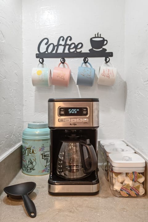 [Kitchen] Get your morning started with our drip coffee maker where we provide coffee grounds, sugar, Splenda and half & half. We also have tea.