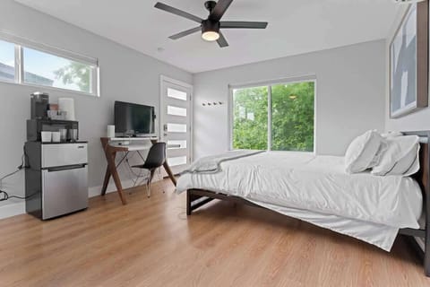 This cozy Austin, Florida retreat features a queen bed, smart TV, workspace & coffee machine, with a large window framing peaceful views capturing the charm of Austin, Florida in Austin, Florida.