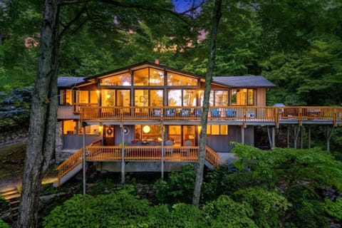 Nestled on 9 private acres near Asheville, this original mid-century Deck House features mahogany trim, panoramic windows, and handcrafted detail!
