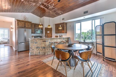Kitchen and hallway lead to the upstairs bedroom with a queen bed and bath.