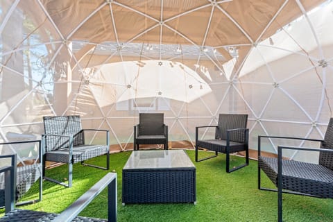 Our enchanting 'snow globe' dome offers a comfortable lounging experience, bringing the outdoors inside in any season.