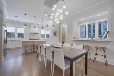 ADJACENT DINING AREA WITH STUNNING CHANDELIER SEATS 8