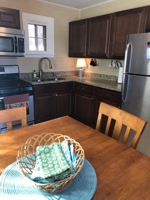 Kitchen with full-sized fridge and stove.