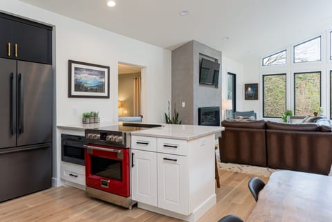 Sleek kitchen with breakfast bar seating for 4, a dishwasher & standard drip coffeemaker.