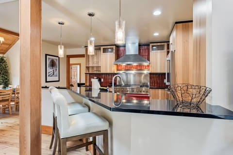 Kitchen: Viking appliances, drip coffee maker, Keurig, cooking utensils, tableware, bar seating