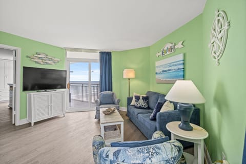Relax in the comfort of a large well-appointed living room with an ocean view.