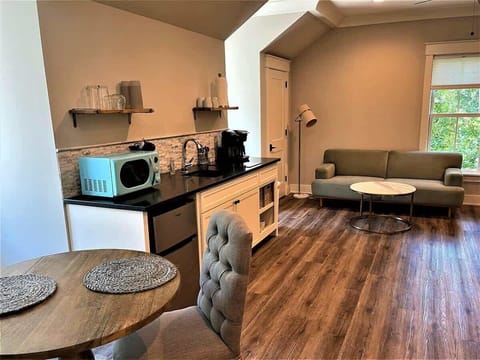 A bright and airy studio layout featuring warm wood-look flooring.