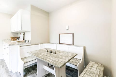 A kitchen and dining area in one, with a cozy table and benches