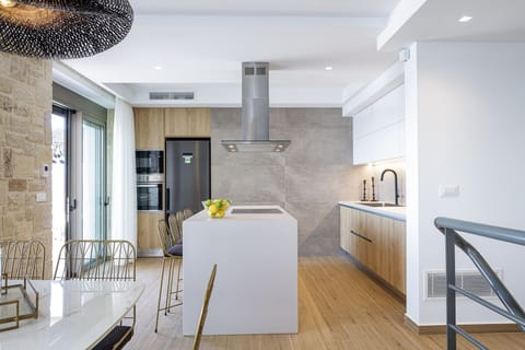Modern kitchen with high-end appliances and an island seating.