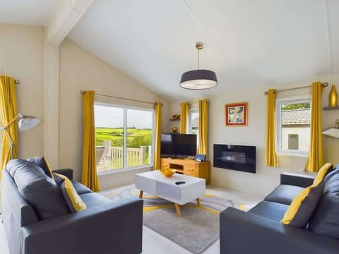 Triple-aspect living room with sliding doors that frame the countryside views and lead to the balcony.