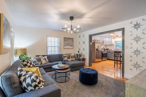 Living room #1 with 75" Smart TV open layout to kitchen.