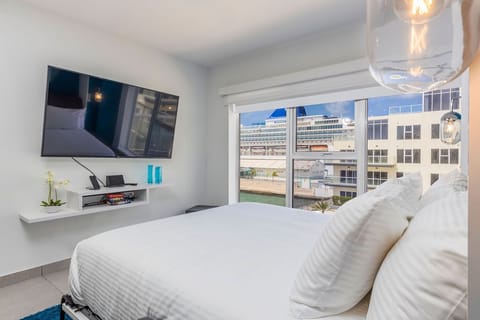 Wake to bright city views from your cozy bed. Crisp linens, modern design, and a flat-screen TV create your perfect downtown retreat.