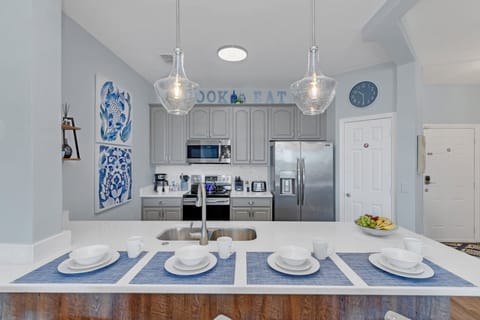 Fully equipped kitchen with dishwasher, stove, oven, microwave and refrigerator with ice maker and water dispenser.