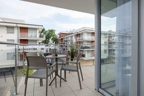 Spacious balcony with outdoor furniture. 