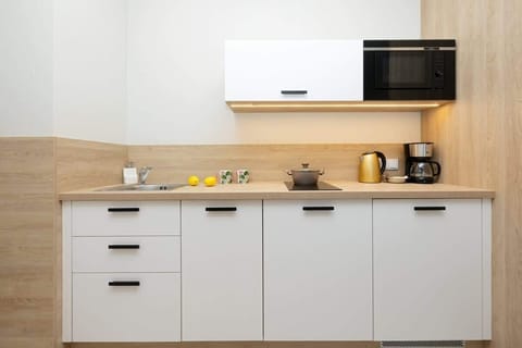 The fully equipped kitchenette includes everything you need for a home-cooked meal.