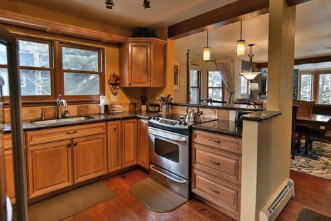 Kitchen - View of the kitchen facing the living room from the back door to the home.