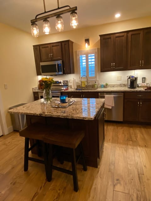 Custom kitchen cabinets granite counters. 
Island with chiseled eve granite top.