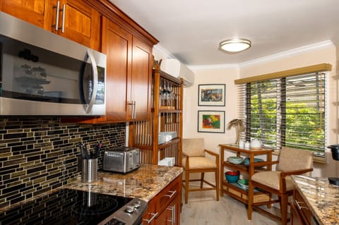 Large, well-appointed kitchen with modern appliances, ample counter space, and a direct view of the ocean as you cook.