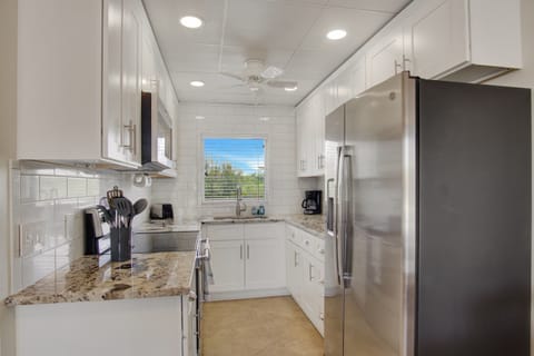 Renovated kitchen, fully stocked with cooking/eating/drinking utensils.