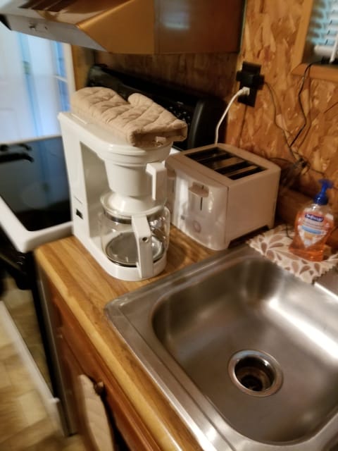 kitchen sink with coffee pot and toaster 