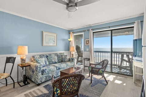 The private balcony off the living room invites you to step outdoors.