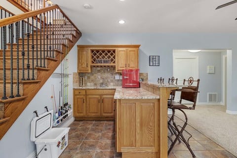 Downstairs, our wet bar features and some extra seating space.
