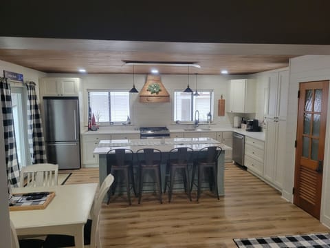 Fully-stocked kitchen with stainless steel appliances.