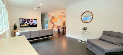 Entry view of living and dining with beautiful tropical mural 