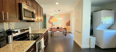 View of dining room from kitchen. Laundry washer/dryer conveniently located.