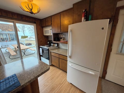 Full kitchen with walkout to brick paver patio.