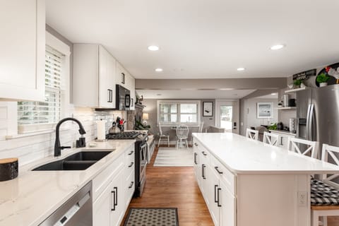 Kitchen is open to eating area and family is opposite the fireplace. 