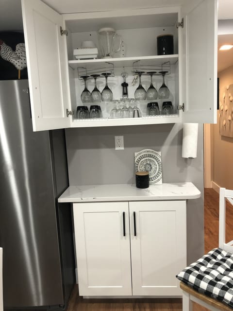 Kitchen equipped with a wine bar & coffee bar on the other side of frig.. 