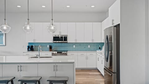 Oversized quartz countertops, 10-foot ceilings, and open concept beach vibes