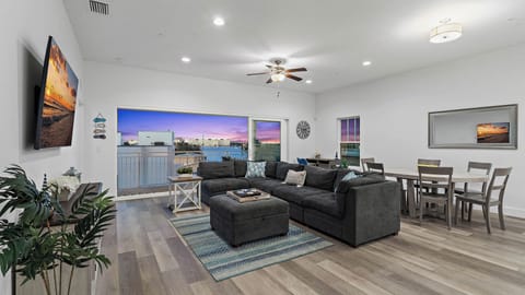 Panoramic water views with an oversized sliding glass door in the living room