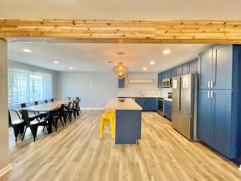 Dining table can sit 12 comfortably plus a high chair, 4 more additional seats on the kitchen island.