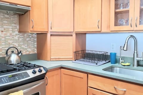 Kitchen has cookware, bakeware, cooking oil, salt, pepper, sugar, and cleaning supplies