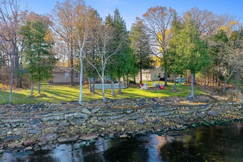 Rocky Shores Retreat from the water — large waterfront deck, private lawn, and kayak rack on Little Sturgeon Bay. Door County vacation rental with 180' of private shoreline.