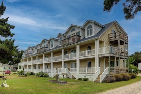 Multi-story beachside property featuring traditional coastal architecture with private balconies and wraparound porches.